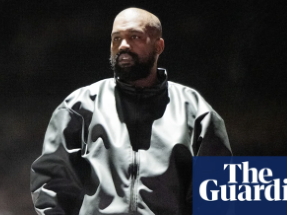 Kanye West on stage during a concert.